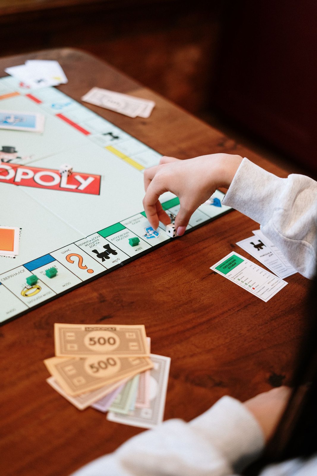 A player moving a green piece on a game board