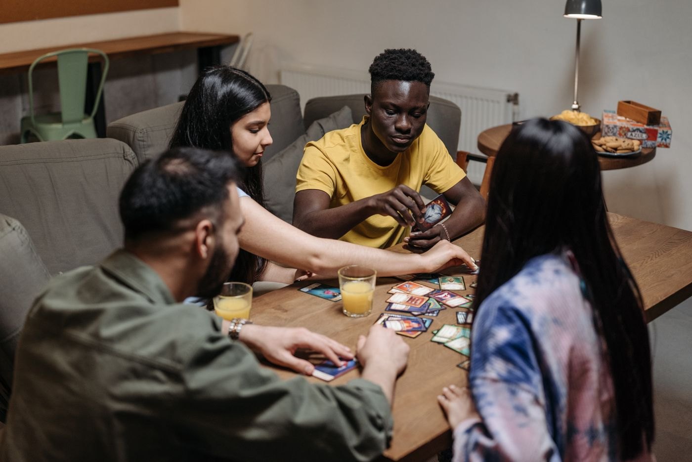 A group talking over cards laid out on a table