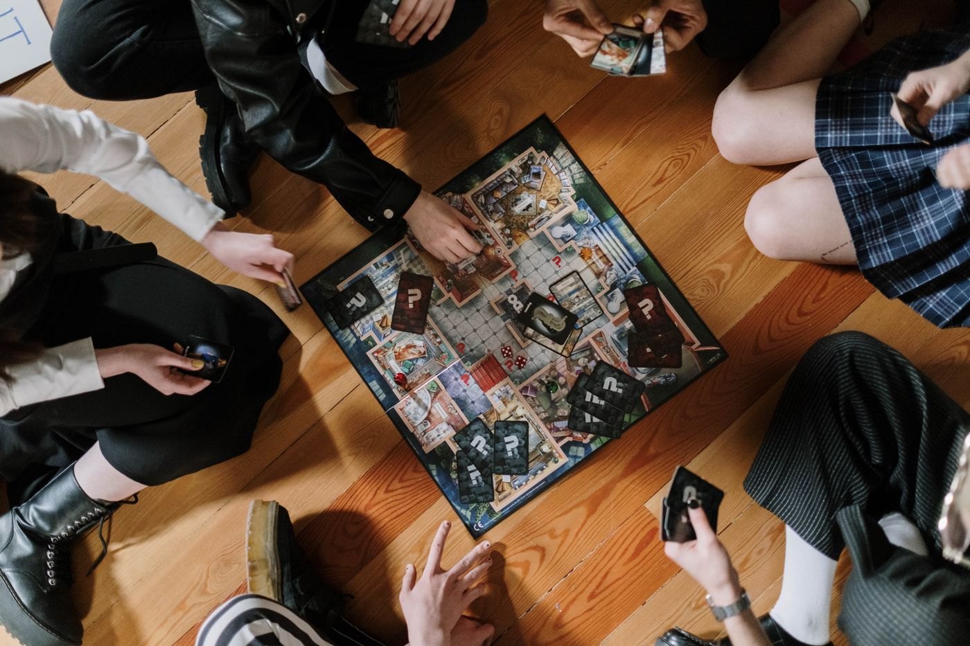 A group seated around a large illustrated board