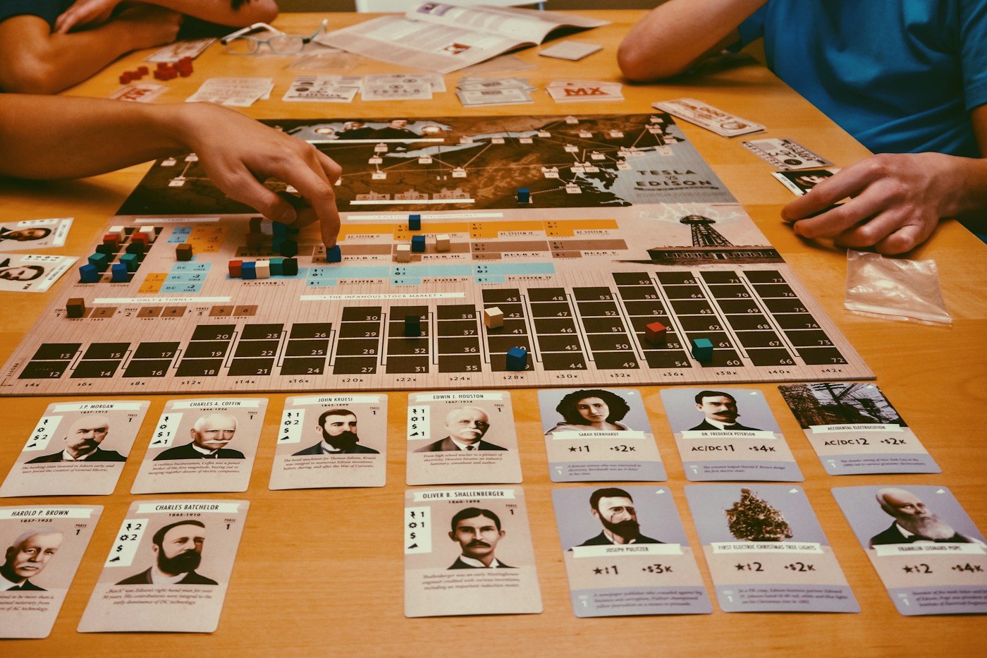 A large game spread across a table with boards, cards and pieces