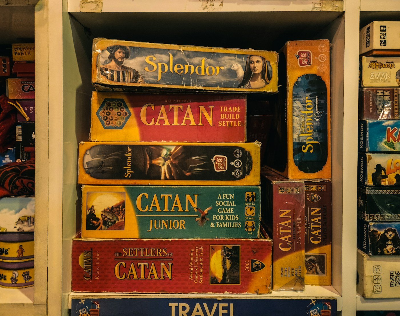 A shelf holding several different editions and types of boxed games