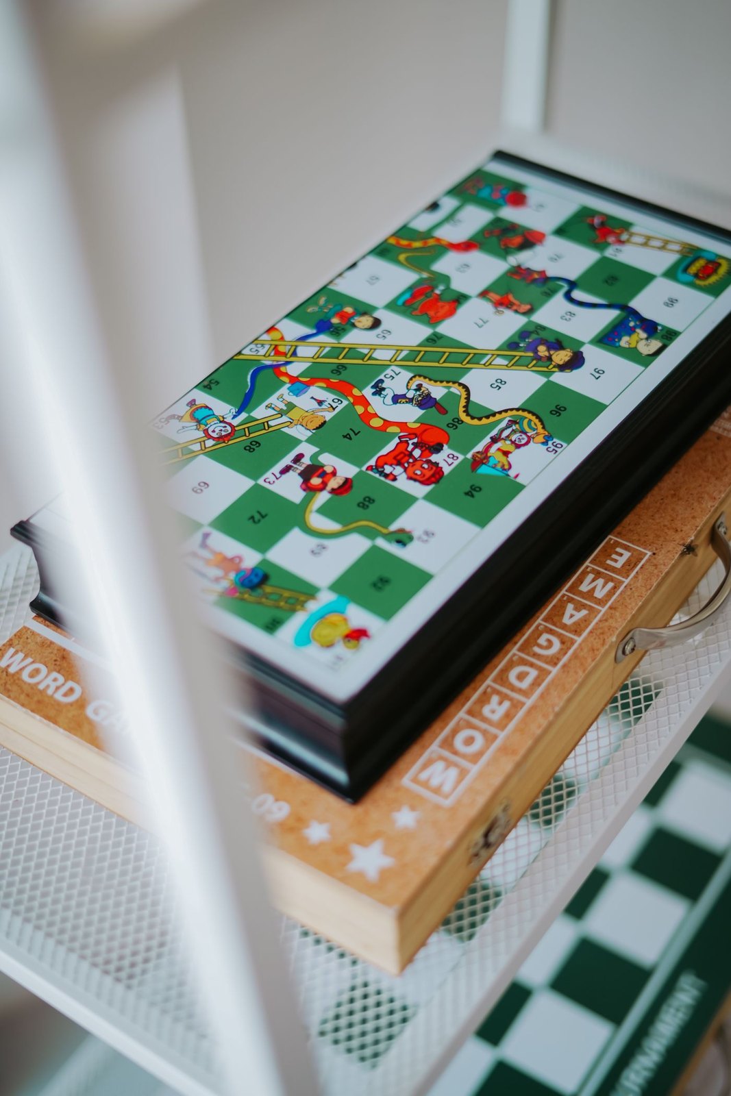 Several boxed board games stacked on a shelf