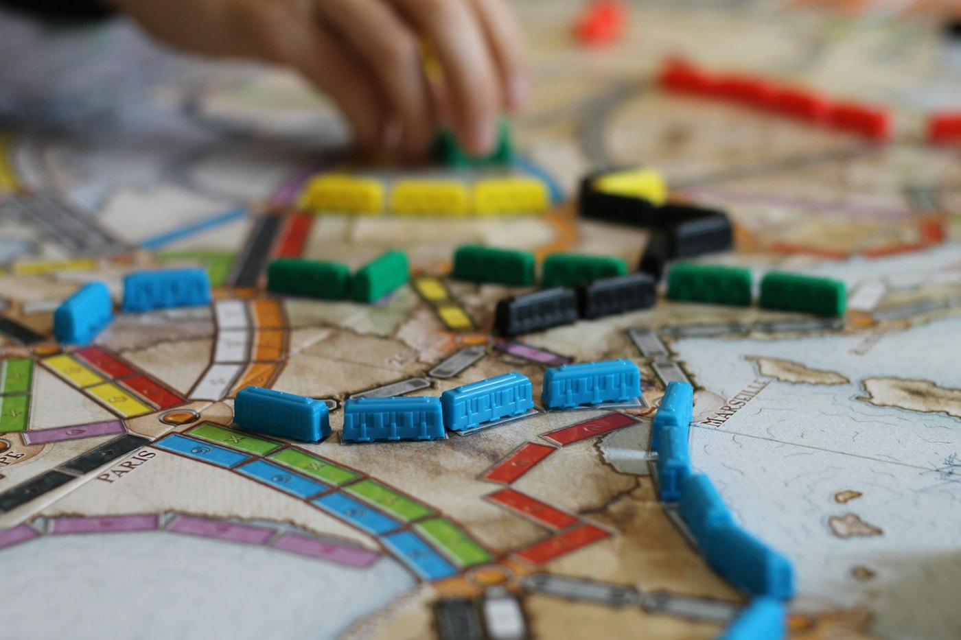 Coloured train pieces placed on routes across a map board