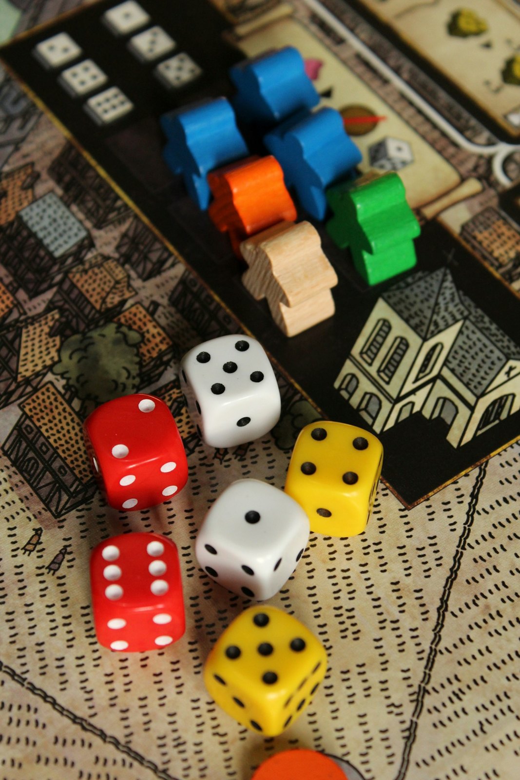 Wooden pieces, dice and cardboard tokens on a game board