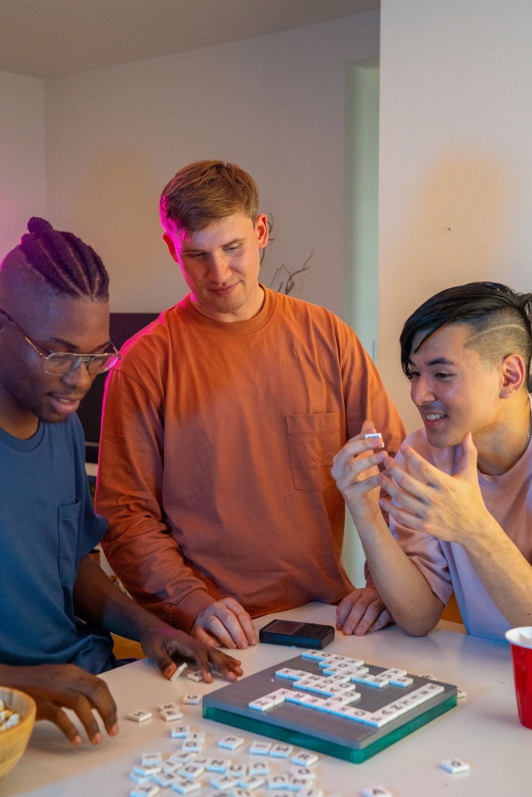 Friends discussing letter tiles together