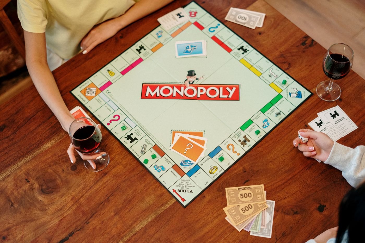 Players seated on different sides of a square game board