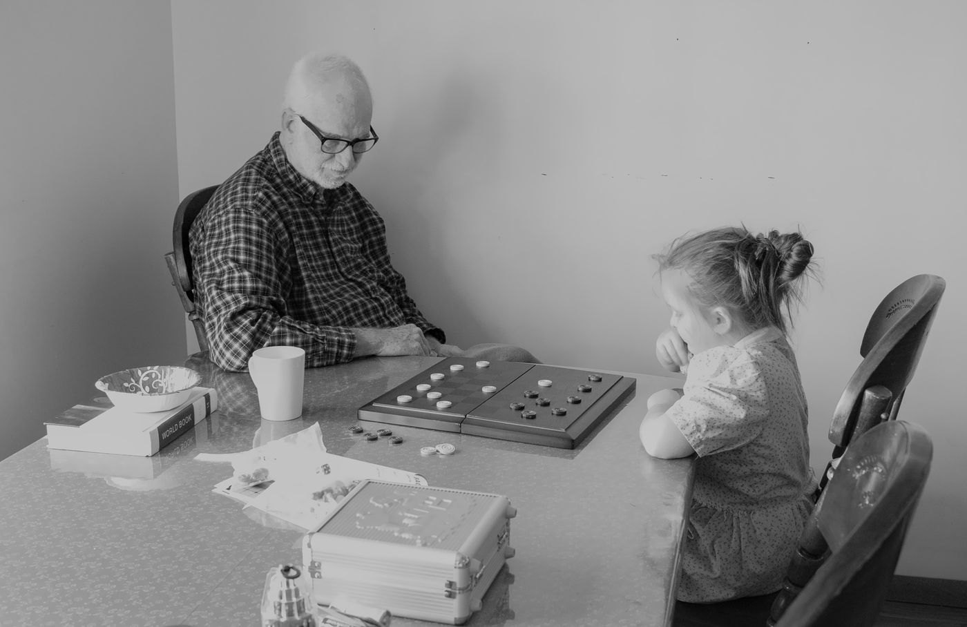 An adult and child playing a board game together