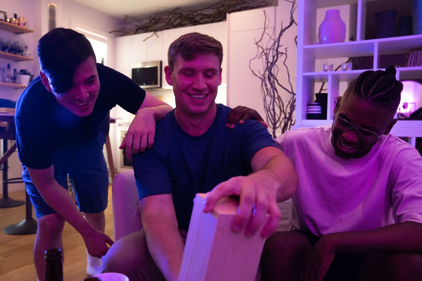 Friends leaning together over a table during play