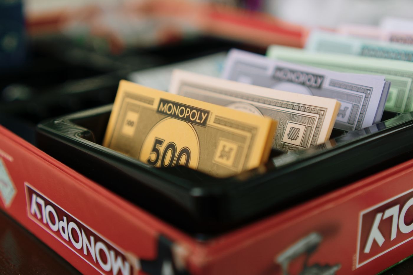 A divided plastic game insert holding paper money