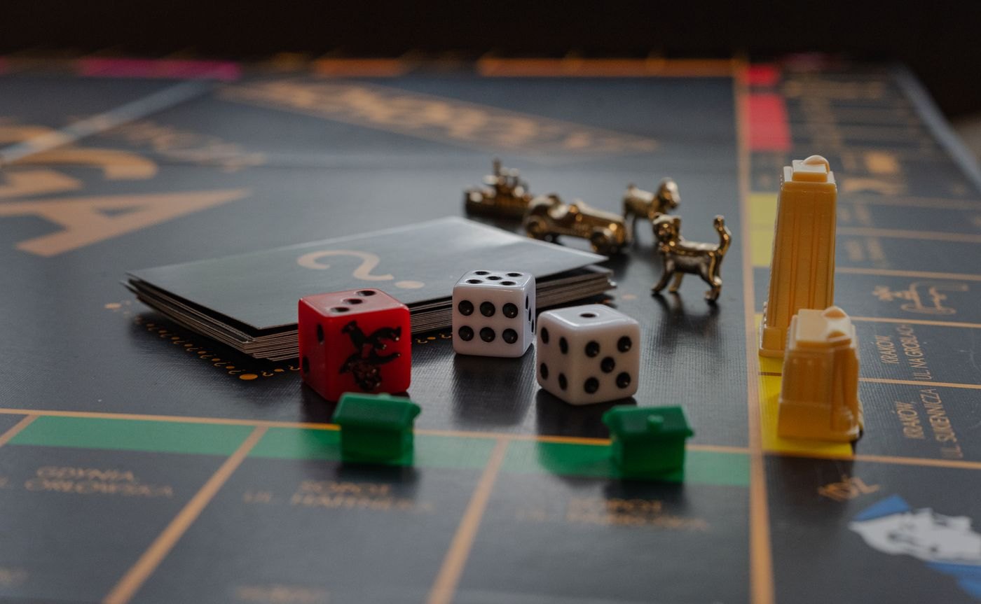 Game cards, dice and metal pieces arranged together