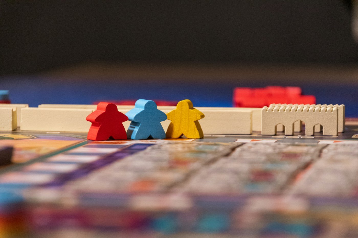 Colourful wooden figures standing on a game board