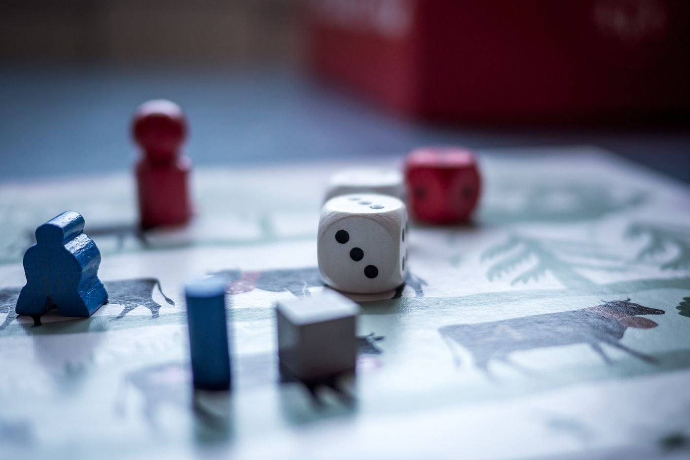 Wooden figures and a die on a game board